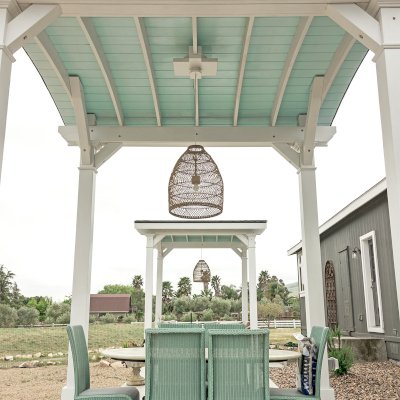  Arched Thick Timber Pavilion (Options: 12' L x 12' Arc W, Douglas-fir, 1 Electrical Wiring Trim, 4-Post Anchor Kit for Concrete, 1 Ceiling Fan Base, No Privacy Panel, No Curtain Rods, 12 ft H, Horizontal Decorative Trims on Posts, Custom Paint). Photo Courtesy of Siino Ventures of Kikrland, Washington.