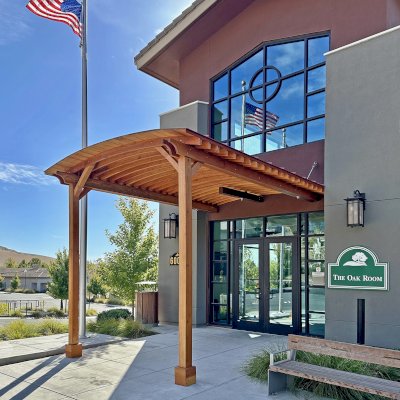 Custom  Arched Thick Timber Pavilion (Options: 10' L x 12' Arc W, Douglas-fir, 2-Post Anchor Kit for Concrete, No Ceiling Fan Base, 11'-5" H Posts, No Privacy Panel, No Curtain Rods, No Decorative Trims on Posts, Transparent Premium Sealant). Pavilion attached as an extension of an existing 5' L roof. Photo Courtesy of R. Cole of Fairfield, CA.