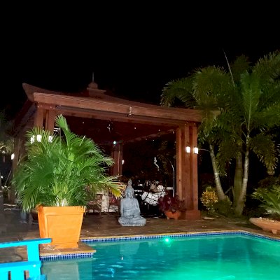 Asian Fusion Pavilion (Options: 18 ft L x 16 ft W, California Redwood, 4-Traditional Asian Fusion Anchoring Set, 1 Electrical Wiring Trim, 9.5 ft H, 1 Ceiling Fan Base, No Privacy Panels, No Curtain Rods, Cherry Stain Premium Sealant). Photo Courtesy of G. Groves Sr. of Royal Palm Beach, Florida.