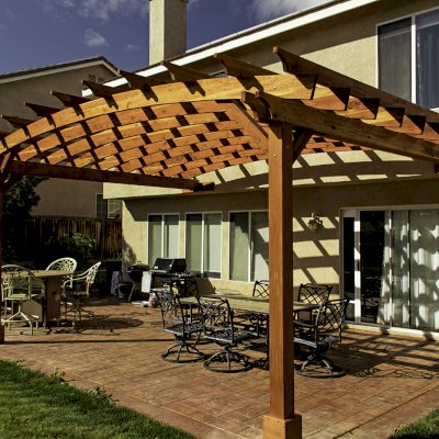 Attached Arched Pergola Kits (Options: 20' L x 15' W, California Redwood, No Electrical Wiring Trim, Arched Roof without Lattice Panels, 2-Post Anchor Kit for Concrete, No Ceiling Fan Base, No Privacy Panels, No Curtain Rods, 10' Post Height, Transparent Premium Sealant). Photo Courtesy of C. Thompson of Corona, CA.