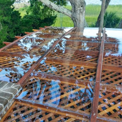 Custom Attached Arched Pergola Kits (Options: 22' L x 26' W, California Redwood, No Electrical Wiring Trim, Rafters at 18" and Slats at 18", 3-Post Anchor Kit for High-Wind, with Transparent Rain Guard, Ceiling Fan Base, No Privacy Panels, No Curtain Rods, 10' Post Height, Transparent Premium Sealant, Attached to Wall by Support Side, Arches are 2x12's by Custom Request). Photo Courtesy of M. Yocco of Hilton Head, South Carolina.