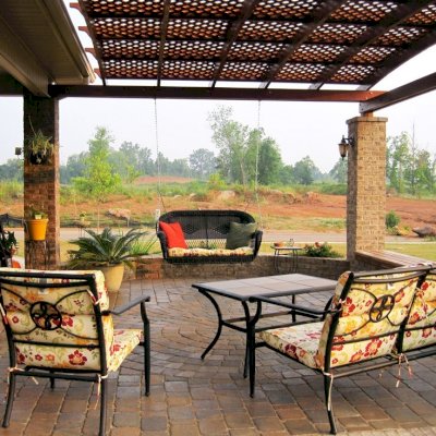 Attached Arched Pergola Kits (Options: 14' L x 18' W, California Redwood, No Electrical Wiring Trim, Arched Roof with Lattice Panels, Widthwise Roof Support Timbers, 2-Post Anchor Kit for Concrete, No Ceiling Fan Base, No Privacy Panels, No Curtain Rods, 9' Post Height,  Transparent Premium Sealant).  Posts wrapped in masonry. Photo courtesy of Mr. Brandon Campbell of  Lenoir City, Tennessee. 