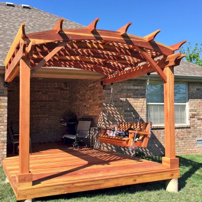 Attached Arched Pergola Kits (Options: 10' x 10', California Redwood, No Electrical Wiring Trim, with Lattice Panels, 2-Post Anchor Kit for Concrete, No Ceiling Fan Base, No Privacy Options, No Curtain Rods, 9ft H, Transparent Premium Sealant) with Deck and Bench Swing by Custom Request. Photo Courtesy of Telory of A. of Springfield, MO.. 