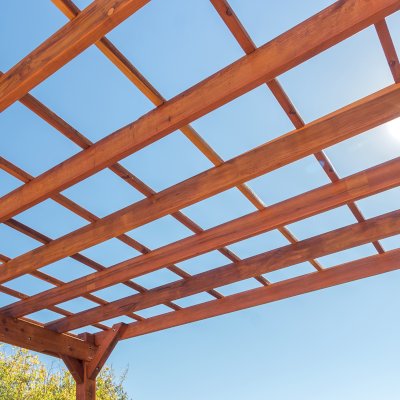Attached Garden Perglola (Options: 12'-6" x 16', California Redwood, Open Roof with Slats at 18", Rafters at 18", Attached to the Wall by Rafter Side, 2-Post Anchor Kit for Concrete, 1 Lattice Privacy Panel, No Ceiling Fan Base, Transparent Premium Sealant). Photo Courtesy of S. Abbasi of Newbury Park, CA.