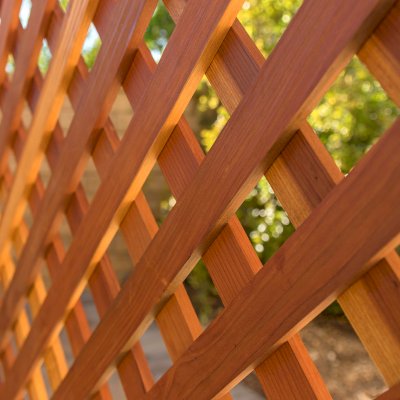 Attached Garden Perglola (Options: 12'-6" x 16', California Redwood, Open Roof with Slats at 18", Rafters at 18", Attached to the Wall by Rafter Side, 2-Post Anchor Kit for Concrete, 1 Lattice Privacy Panel, No Ceiling Fan Base, Transparent Premium Sealant). Photo Courtesy of S. Abbasi of Newbury Park, CA.