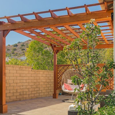 Attached Garden Perglola (Options: 12'-6" x 16', California Redwood, Open Roof with Slats at 18", Rafters at 18", Attached to the Wall by Rafter Side, 2-Post Anchor Kit for Concrete, 1 Lattice Privacy Panel, No Ceiling Fan Base, Transparent Premium Sealant). Photo Courtesy of S. Abbasi of Newbury Park, CA.