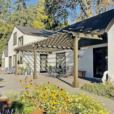 Attached Garden Pergola (Options: 32' x 14', California Redwood, Open Roof with Slats at 18", Rafters at 18", 3-Post Anchor Kit for Concrete, No Ceiling Fan Base, Gray Oil-Based Primer [Paint Applied by Customer]). Photo Courtesy of T. Elliott of Portland, Oregon.