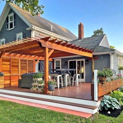 Attached Garden Pergolas (Options: 20' L x 17'-6" W, Attached to Wall by Rafter Side, California Redwood, No Electrical Wiring Trim, No Ceiling Fan Base, Open Roof with Slats at 12", No Rain Guard, 3-Post Anchor Kit for Wood, with Two 6x6 Posts and One 4x4 Post,  with 3x8 Extra Posts Against Wall by Custom Request, Transparent Premium Sealant). Photo Courtesy of I. Clarkson of Abington, Massachusetts.