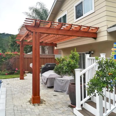 Attached Garden Pergolas (Options: 20' L x 10' W, Mature Redwood, No Electrical Wiring Trim, 2-Post Anchor Kit for High-Wind, Open Roof with Slats at 12", Rafters at 18", Vertical post decorative trim, Transparent Premium Sealant). Photo Courtesy of D. Abrams of San Jose, California.