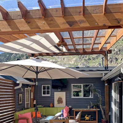 Attached Garden Perglola (Options: 16' x 16', California Redwood, Open Roof with Slats at 18", Rafters at 18", Attached to Existing Posts, with Transparent Rain Guard, 2-Post Anchor Kit for Concrete, No Privacy Panel, 1 Ceiling Fan Base, Transparent Premium Sealant). Photo Courtesy of D. Martin of Georgetown, CO.