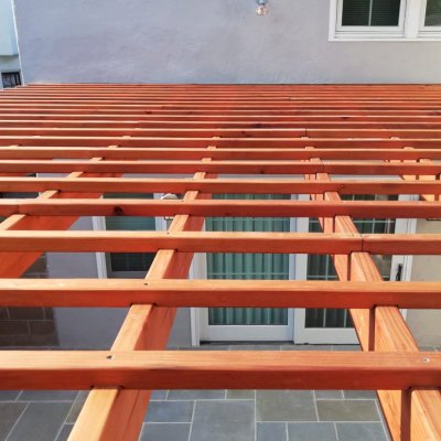 Attached Garden Pergola (Options: 13'-6" x 16'-6", Mature Redwood, Open Roof with Slats at 6", Rafters at 18", 2-Post Anchor Kit for Concrete, No Ceiling Fan Base, Transparent Premium Sealant). Photo Courtesy of J. Mason of Alameda, California.