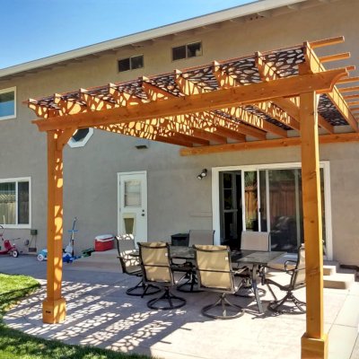 Attached Garden Pergolas (Options: 15' x 14', Attached to Wall by Support Side, with Transparent Rain Guard, Douglas-fir, No Electrical Wiring Trim, Open Roof with Slats at 18", 2-Post Anchor Kit for Concrete, Transparent Premium Sealant). Customer Added a Custom Lattice Between the Rafters and the Rain Guard. Photo Courtesy of L. Rise of Santa Rosa, California.