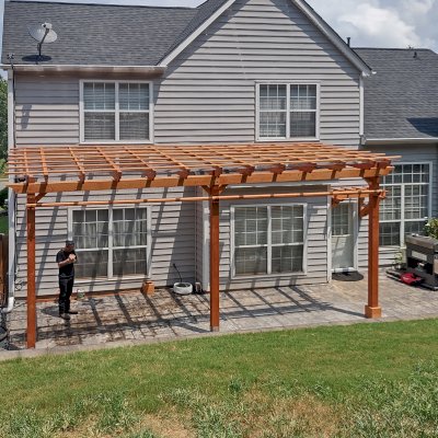 Attached Garden Pergolas (Options: 24'-6" L x 10' W, Attached to Wall by Support Side, Douglas-fir, Electrical Wiring Trim for 1 Post, 2 Ceiling Fan Bases, Open Roof with Slats at 18", with Rain Guard, 3-Post Anchor Kit for Concrete, Sloped Rafters by Custom Request, Transparent Premium Sealant).