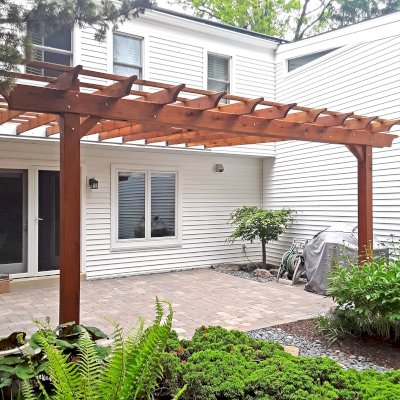 Attached Garden Pergola (Options: 18' x 15', California Redwood, Open Roof with Slats at 18", Rafters at 18", 2-Post Anchor Kit for Concrete, 1 Ceiling Fan Base, Transparent Premium Sealant). Custom framed 2' x 2' Polycarbonate Rain Guard centered atop ceiling fan base to protect fan from moisture. Photo Courtesy of M. Holland of Potomac, Maryland.