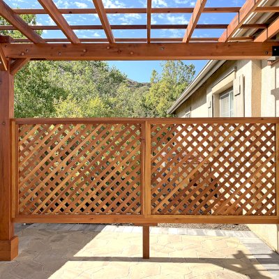 Attached Garden Perglola (Options: 12'-6" x 16', California Redwood, Open Roof with Slats at 18", Rafters at 18", Attached to the Wall by Rafter Side, 2-Post Anchor Kit for Concrete, 1 Lattice Privacy Panel, No Ceiling Fan Base, Transparent Premium Sealant). Photo Courtesy of S. Abbasi of Newbury Park, CA.