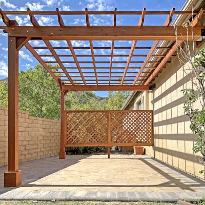 Attached Garden Perglola (Options: 12'-6" x 16', California Redwood, Open Roof with Slats at 18", Rafters at 18", Attached to the Wall by Rafter Side, 2-Post Anchor Kit for Concrete, 1 Lattice Privacy Panel, No Ceiling Fan Base, Transparent Premium Sealant). Photo Courtesy of S. Abbasi of Newbury Park, CA.