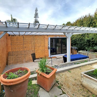 Attached Garden Pergola (Options: 27' L x 14'-4'' W, Attached to Wall by Rafters Side, Mosaic Douglas-fir, Electrical Wiring Trim for 1 Post, Post Anchor Kit for Concrete, Open Roof with Slats at 12", Rafters at 18", No Post Decorative Trims, Gray Oil-Based Primer). Photo Courtesy of V. Spataro of Los Angeles, CA.