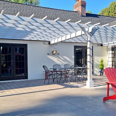 Attached Garden Pergola (Options: 32' x 14', California Redwood, Open Roof with Slats at 18", Rafters at 18", 3-Post Anchor Kit for Concrete, No Ceiling Fan Base, Gray Oil-Based Primer). Photo Courtesy of T. Elliott of Portland, Oregon.