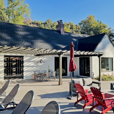 Attached Garden Pergola (Options: 32' x 14', California Redwood, Open Roof with Slats at 18", Rafters at 18", 3-Post Anchor Kit for Concrete, No Ceiling Fan Base, Gray Oil-Based Primer [Paint Applied by Customer]). Photo Courtesy of T. Elliott of Portland, Oregon.