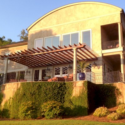 Attached Garden Pergolas (Options: 30' L x 14' W, Mature Redwood, No Electrical Wiring Trim, Open Roof with Slats at 12", Posts Wrapped with Columns After Installation, Transparent Premium Sealant). Photo Courtesy of Casey Graybeal of Gainesville, Georgia.