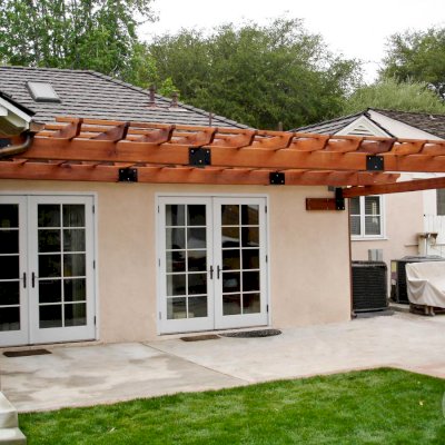 Attached Garden Pergolas (Options:10' L x 14' W, Attached to Wall by 2 Sides by Custom Request, Mature Redwood, No Electrical Wiring Trim, Open Roof with Slats at 18", 1-Post Anchor Kit for Concrete, Transparent Premium Sealant).