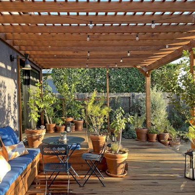 Attached Garden Pergolas (Options: 45'-6" L, One Section is 13' W and the Other Section is 15', Attached to Wall by Rafters Side, California Redwood, 1 Ceiling Fan Base, No Electrical Wiring Trim, Open Roof with Slats at 6", No Decorative Trims on Posts, 5-Post Anchor Kit for High-Wind, Transparent Premium Sealant). Photo Courtesy of D. Herman of Livermore, California.