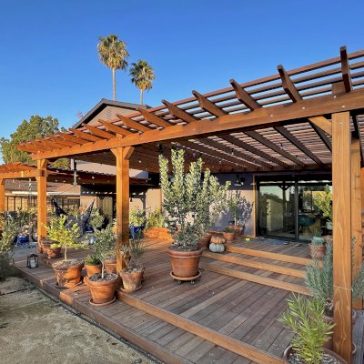Attached Garden Pergolas (Options: 45'-6" L, One Section is 13' W and the Other Section is 15', Attached to Wall by Rafters Side, California Redwood, 1 Ceiling Fan Base, No Electrical Wiring Trim, Open Roof with Slats at 6", No Decorative Trims on Posts, 5-Post Anchor Kit for High-Wind, Transparent Premium Sealant). Photo Courtesy of D. Herman of Livermore, California.