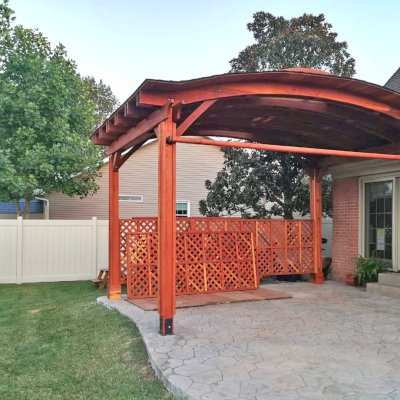 Backyard Pavilion Kits (Options: 12' L x 18' Arc W, California Redwood,  1 Electrical Wiring Trim, 4-Post Anchor Kit for High-Wind, No Ceiling Fan Base, 2 Privacy Panels, 1 Curtain Rod, 9.5 ft Post Height, Transparent Premium Sealant). Final Privacy Panel Install Pending. Photo Courtesy of C Liebo of Newburgh, Indiana.