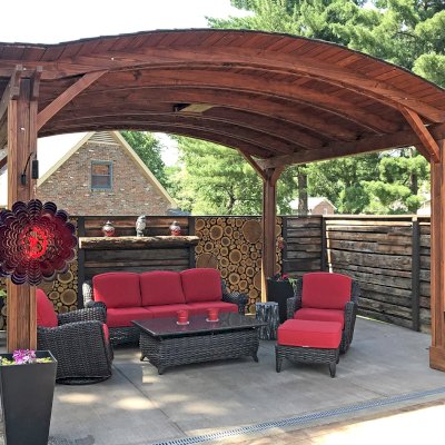 Backyard Pavilion Kits (Options: 12' L x 14' Arc W, California Redwood, 2 Post Electrical Wiring Trim, 4-Post Anchor Kit for Stone, Add Ceiling Fan Base, No Privacy Panels, No Curtain Rods, 9 ft Post Height, Coffee-Stain Premium Sealant). Photo Courtesy of Jacques & Kristi.