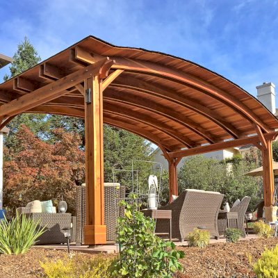 Backyard Pavilion Kits (Options: 12' L x 22' Arc W, California Redwood, No Electrical Wiring Trim, 4-Post Anchor Kit for High-Wind, No Ceiling Fan Base, No Privacy Panels, No Curtain Rods, 9.5 ft Post Height, Transparent Premium Sealant). Photo Courtesy of S. Bell of Santa Rosa, CA.