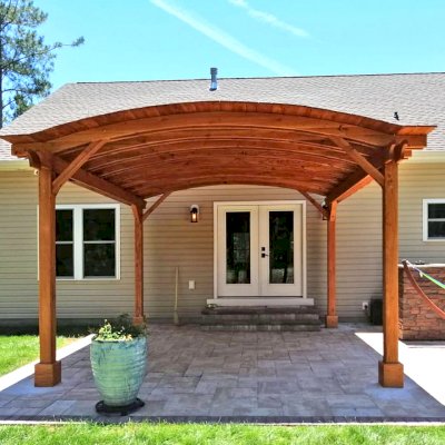 Backyard Pavilion Kits (Options: 16' L x 15' Arc W, Douglas-fir, No Post Electrical Wiring Trim, 4-Post Anchor Kit for Concrete, No Ceiling Fan Base, No Privacy Panels, No Curtain Rods, 9 ft Post Height, Transparent Premium Sealant). Photo Courtesy of S. Fly of Millsboro, Delaware.