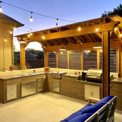 Backyard Pavilion Kits (Options: 18' x 7', California Redwood, Electrical Wiring Trim Kit for 1 Post, 4-Post Anchor Kit for Wood, No Ceiling Fan Base, 1 Privacy Panel with Louvers, No Curtain Rods, 9.5 ft Post Height, Coffee-Stain Premium Sealant). Photo Courtesy of D. Balls of Draper, Utah.
