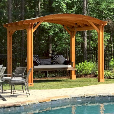 Backyard Pavilion Kits (Options: 12' L x 10' Arc W, Douglas-fir, No Electrical Wiring Trim, 4-Post Anchor Kit for High-Wind, No Ceiling Fan Base, No Privacy Panels, No Curtain Rods, 9 ft Post Height, Transparent Premium Sealant). Swing added by customer. Photo Courtesy of E. Schechtman of Wake Forest, NC.