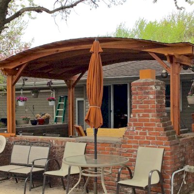 Backyard Pavilion Kits (Options: 20' x 12', California Redwood, No Electrical Wiring Trim Kit, 4-Post Anchor Kit for Stone, No Ceiling Fan Base, No Privacy Panels, No Curtain Rods, 10 ft Post Height, Transparent Premium Sealant). Photo Courtesy of Gary C. of Blaine, Minnesota.