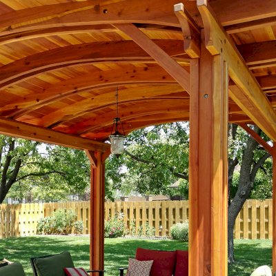 Backyard Pavilion Kits (Options: 14' L x 12' Arc W, California Redwood, No Electrical Wiring Trim, 4-Post Anchor Kit for Concrete, No Ceiling Fan Base, No Privacy Panels, No Curtain Rods, 9 ft Post Height, Transparent Premium Sealant). Photo Courtesy of B. Hardesty of Great Bend, KS.