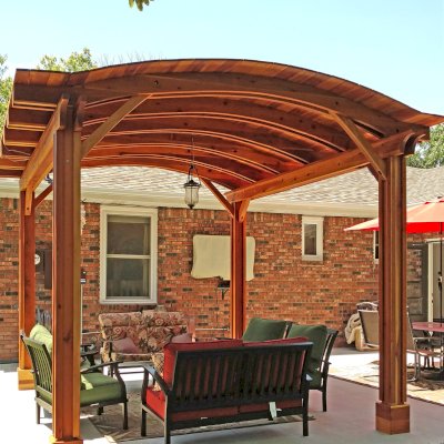 Backyard Pavilion Kits (Options: 14' L x 12' Arc W, California Redwood, No Electrical Wiring Trim, 4-Post Anchor Kit for Concrete, No Ceiling Fan Base, No Privacy Panels, No Curtain Rods, 9 ft Post Height, Transparent Premium Sealant). Photo Courtesy of B. Hardesty of Great Bend, KS.