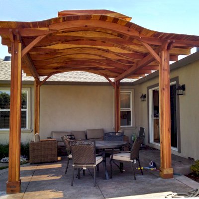 Backyard Pavilion Kits (Options: 18' x 15', California Redwood, No Electrical Wiring Trim, 4-Post Anchor Kit for Stone, No Ceiling Fan Base, No Privacy Panels, No Curtain Rods, 9.5 ft Post Height, Transparent Premium Sealant). Note: Skylights are custom add-on we can do for any size Pavilion roof. Overhang is longer on one side than other by custom request (standard overhang is 12