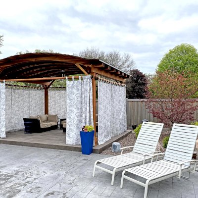 Backyard Pavilion Kits (Options: 15' L x 18' Arc W, California Redwood, 2 Post Electrical Wiring Trims, 4-Post Anchor Kit for Concrete, 1 Ceiling Fan Base, No Privacy Panels, 4 Curtain Rods, 9 ft Post Height, Transparent Premium Sealant). Photo Courtesy of S. McDonald of Lake Barrington, Illinois.
