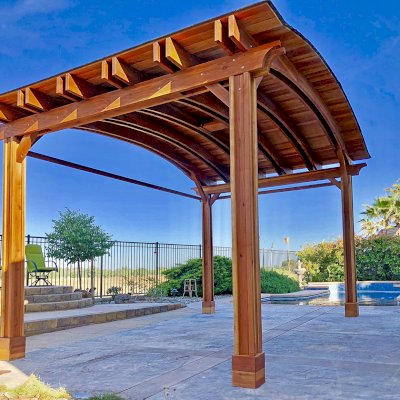 Backyard Pavilion Kits (Options: 14' L x 22' Arc W, California Redwood, 1 Post Electrical Wiring Trim, 4-Post Anchor Kit for Concrete, With 2 Ceiling Fan Bases, No Privacy Panels, 2 Curtain Rods, 9.5 ft Post Height, Transparent Premium Sealant). Photo Courtesy of T. Bauer of Sacramento, CA.