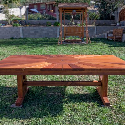Custom Design (Options: 8' L x 46" W, California Redwood [Central Section in Old-Growth Redwood], Squared Corners, with Umbrella Hole, Custom Tabletop). Photo Also Shows a Dustin's Face to Face Glider in Background.
