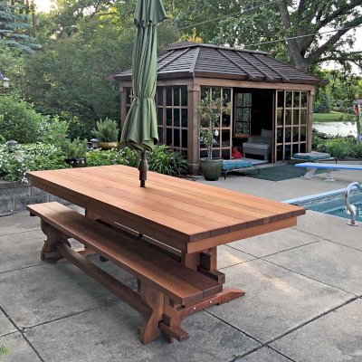 Baja Outdoor Redwood Dining Table (Options: 8 ft L, 42 inches W, Side Benches [Only 1 Shown in Photo], California Redwood, Standard Tabletop [with Lengthwise Boards by Custom Request], Squared Corners, 2" Umbrella Hole, Transparent Premium Sealant). Dream Gazebo Shown in Background. Photo Courtesy of D. Womack of White Bear Lake, Minnesota.