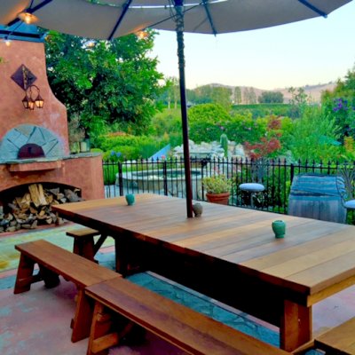 Baja Outdoor Redwood Dining Table (Options: 10 ft L, 48 inches W, Side & End Benches, 2 Half Benches Per Side, California Redwood, Standard Tabletop, Squared Corners, 2" Umbrella Hole, Transparent Premium Sealant). Photo Courtesy of Arjun Reyes of Santa Rosa Valley, CA.