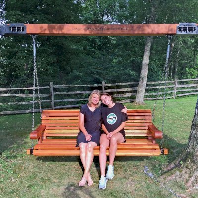 Bench Swings (Seats Only) (Options: XL Garden Bench, California Redwood, Ensenada Seat Design, Custom Engraving, Custom Heavy Duty Hinged Steel Harnesses with a 6x6 Beam, Transparent Premium Sealant). Custom Tree Rings and Beam Designed by Forever Redwood to Attach Swing to the 2 Trees. Photo Courtesy of P. Scaturro of Bedford, New York.