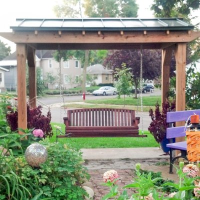 Bench Swings (Seats Only) (Options: Large Garden Bench, Old-Growth Redwood, Luna Backrest Seat, No Engraving, All Beam Hanging Hardware, Cherry Stain Premium Sealant). Photo Courtesy of Robert MacDonald of Minneapolis, Minnesota. Pergola is a custom job made in Douglas-fir.