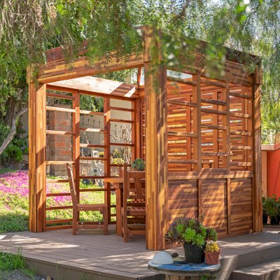Catalina Island Pergola (Options: 8' x 8', Mosaic Redwood, 8' Post Height, Transparent Premium Sealant). Photo Also Shows a Round Patio Table with Segovia Chairs.