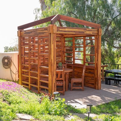 Catalina Island Pergola (Options: 8' x 8', Mosaic Redwood, 8' Post Height, Transparent Premium Sealant). Photo Also Shows a Round Patio Table with Segovia Chairs.