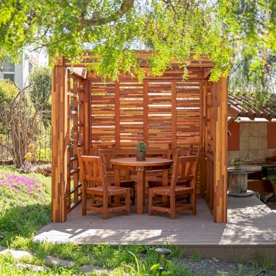 Catalina Island Pergola (Options: 8' x 8', Mosaic Redwood, 8' Post Height, Transparent Premium Sealant). Photo Also Shows a Round Patio Table with Segovia Chairs.