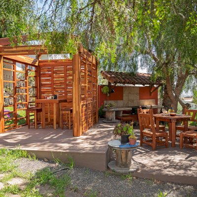 Catalina Island Pergola (Options: 8' x 8', Mosaic Redwood, 8' Post Height, Transparent Premium Sealant). Photo Also Shows a Glady's Table Under the Pergola and a Round Patio Table with Segovia Chairs.