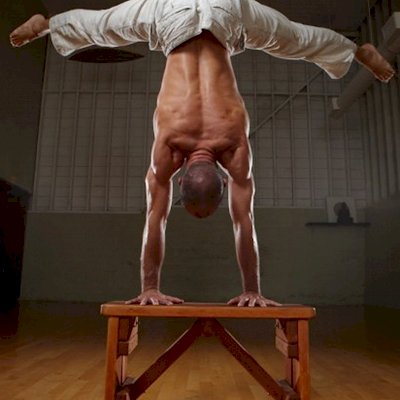 San Francisco Yoga Master Reed Taylor using a custom sized Classic Wooden Picnic Bench for exercising. (Options: 1 ft 8in Length, 17 1/2 in Heigth, California Redwood, Rounded Corner, Custom Engraving, Transparent Premium Sealant).