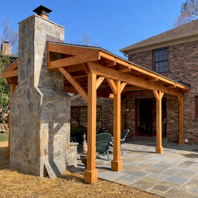 Custom Wood Pavilion Kits (Options: Douglas-fir, 1 Electrical Wiring Trim Kit, With 2 Ceiling Fan Bases, with Skylights by Custom Request, Posts Anchor Kit for High-Wind, Transparent Premium Sealant). Extra post added to fit the pavilion around the fireplace. Photo Courtesy of A. Lotwin of Potomac, Maryland.